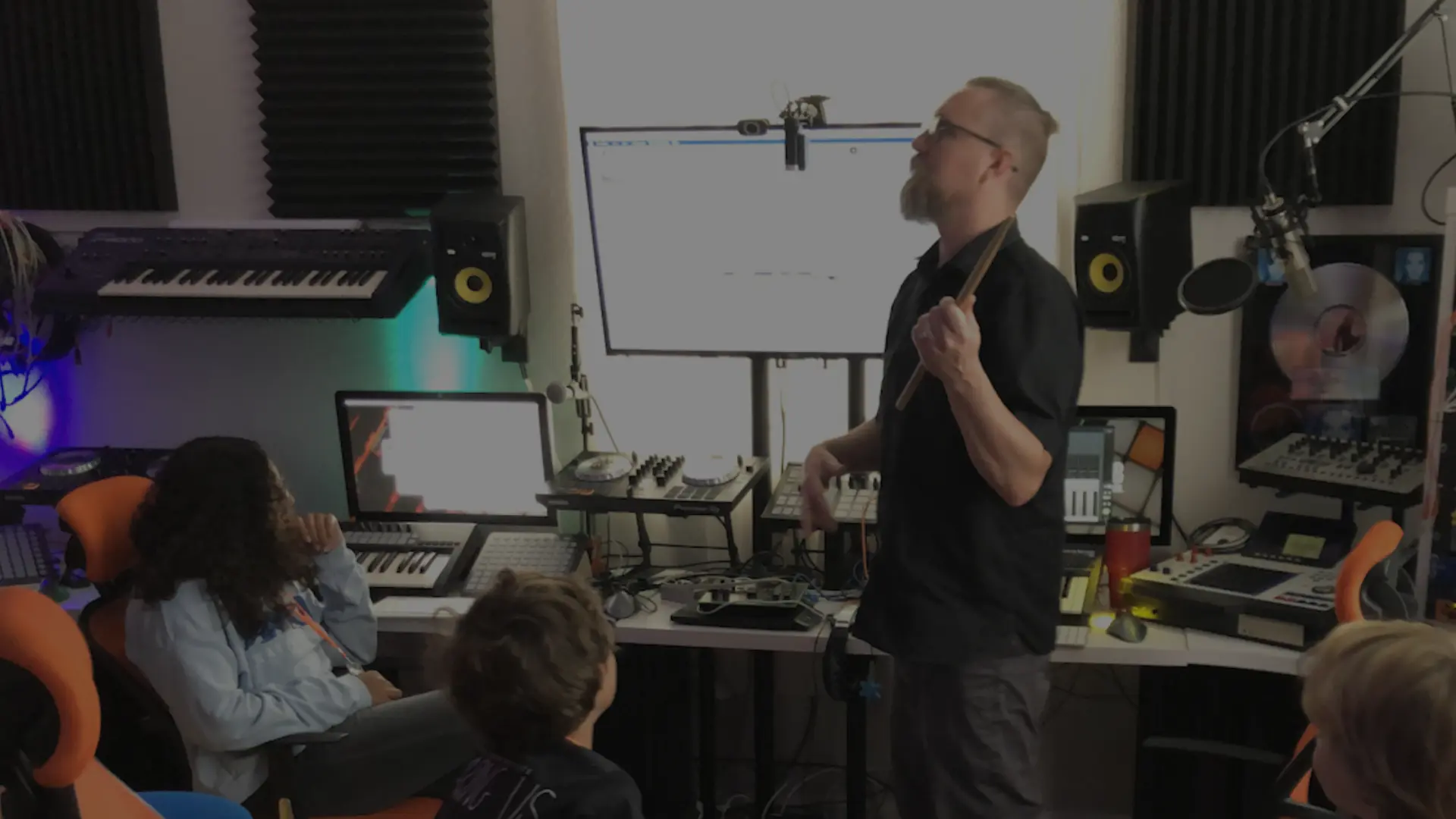Travis teaching kids music production at AMP Music lab in West palm Beach Florida